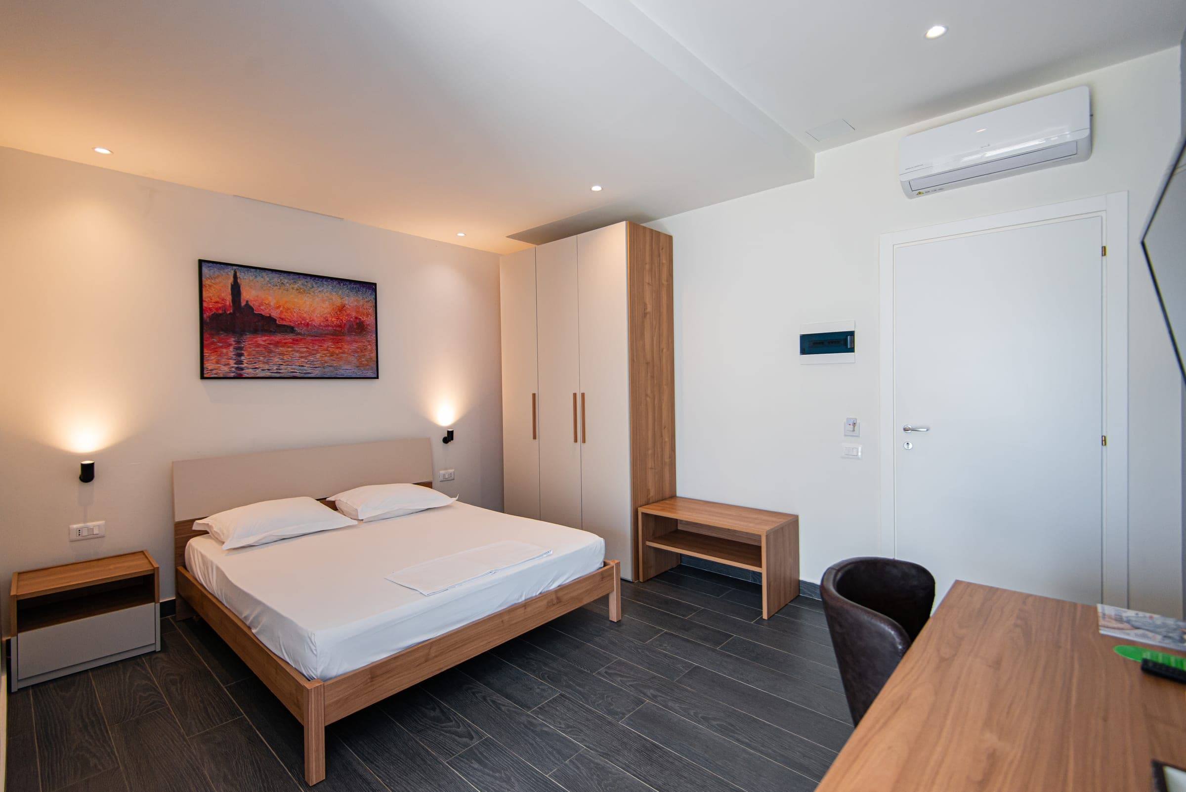 Deluxe Double Room with a king bed and wardrobe